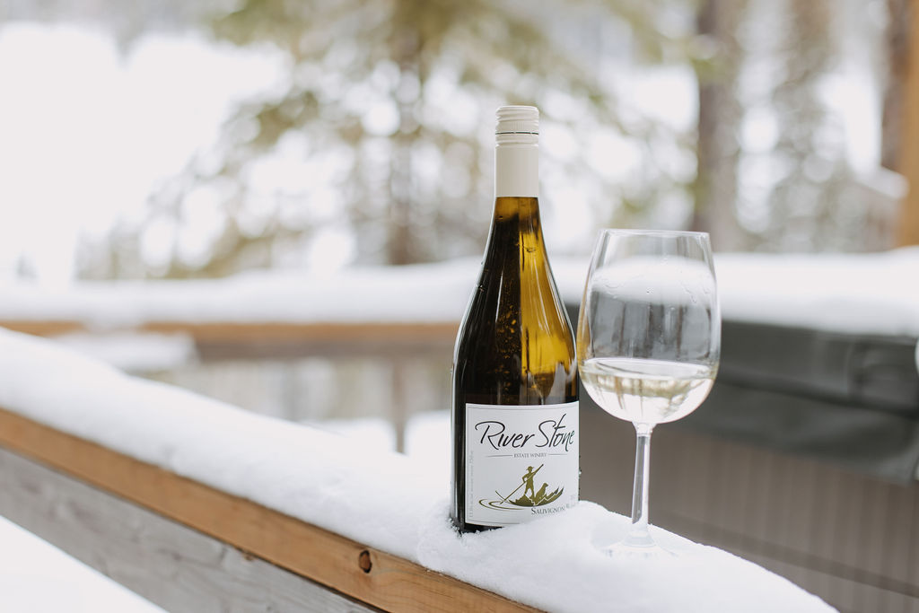 River Stone Wine bottle and glass in snow