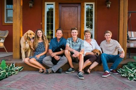 Family on front step of River Stone Estate