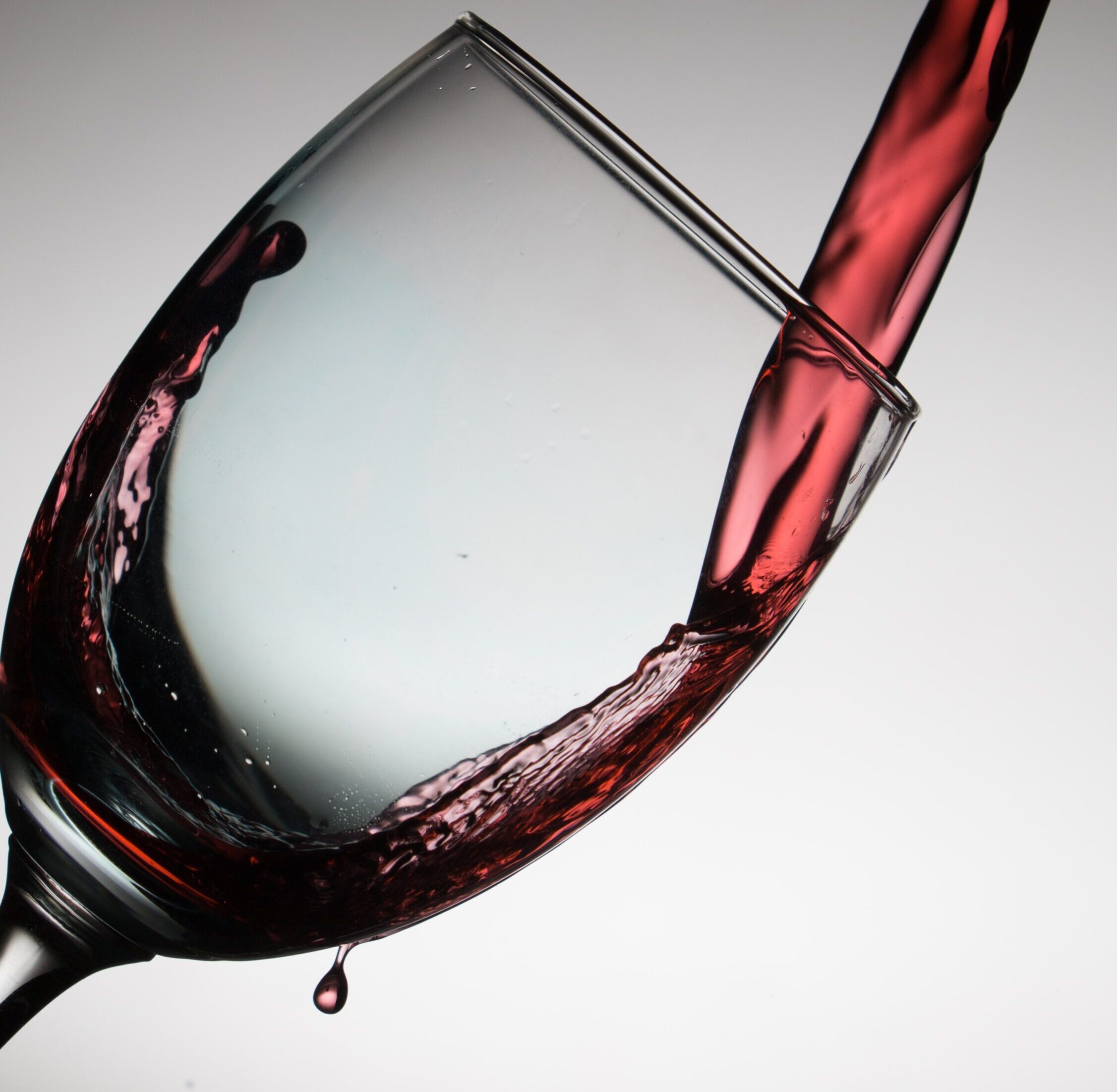 close up of wine being poured into a wine glass